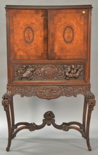 Appraisal: Carved walnut victrola cabinet having two burl walnut doors over