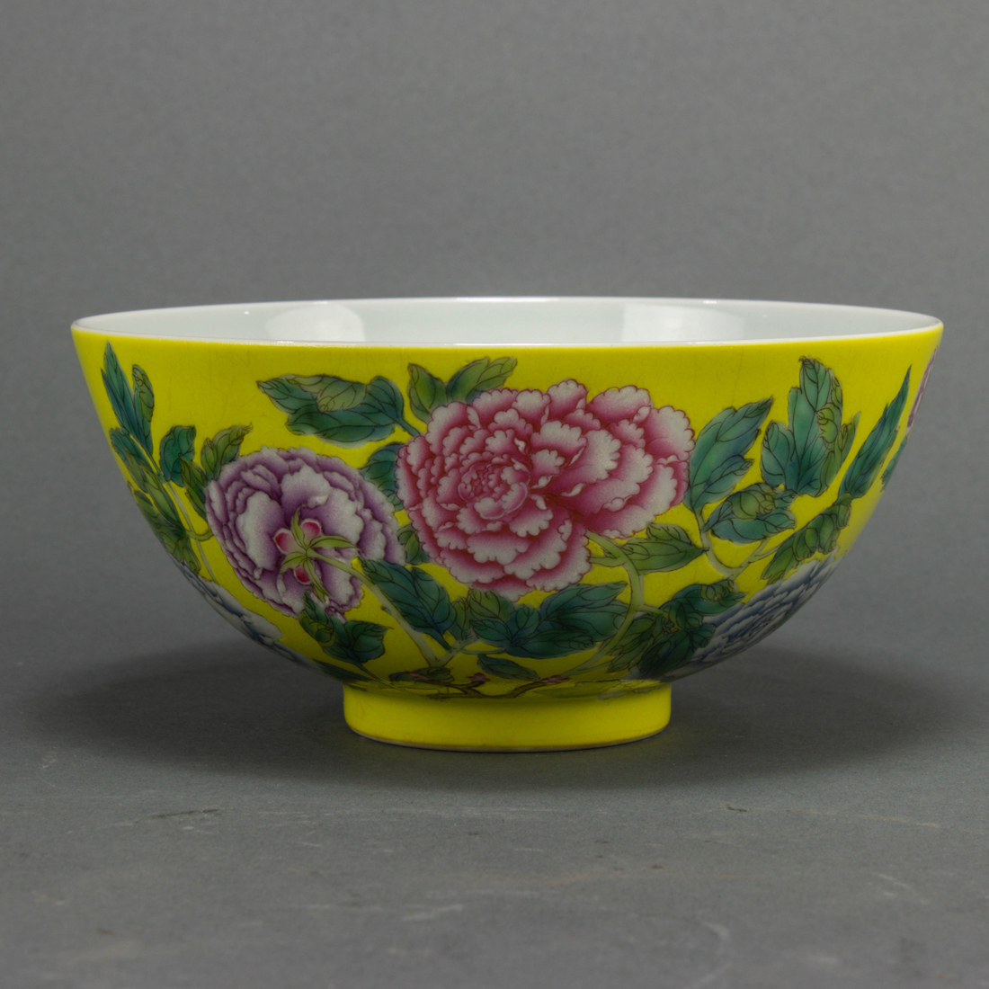 Appraisal: Chinese famille rose yellow-ground bowl decorated with large peony blooms