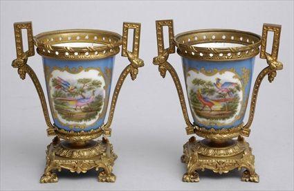 Appraisal: PAIR OF LOUIS XVI-STYLE GILT-METAL MOUNTED SEVRES PORCELAIN CUPS Each