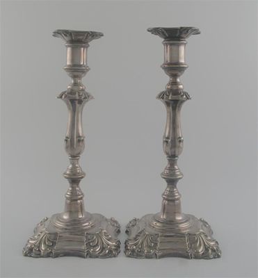 Appraisal: A pair of plated candlesticks with shaped square bases and