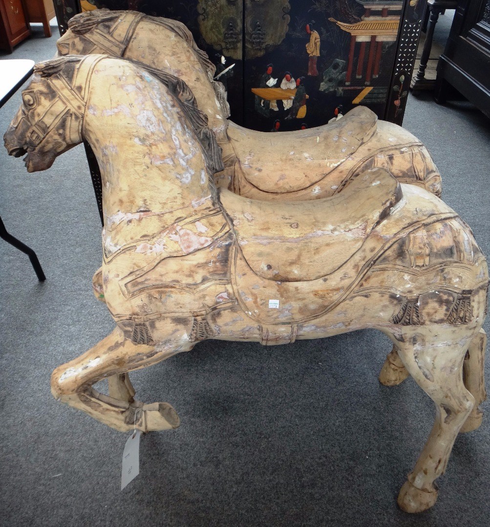 Appraisal: Two carved wooden fairground horses and metal footplates each devoid