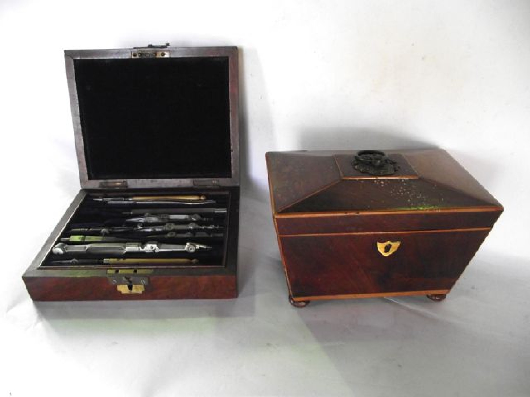 Appraisal: A mahogany veneered caddy with inlay to border raised on