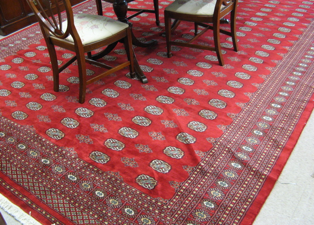 Appraisal: PAKISTANI BOKHARA CARPET overall Turkoman gol design on crimson ground