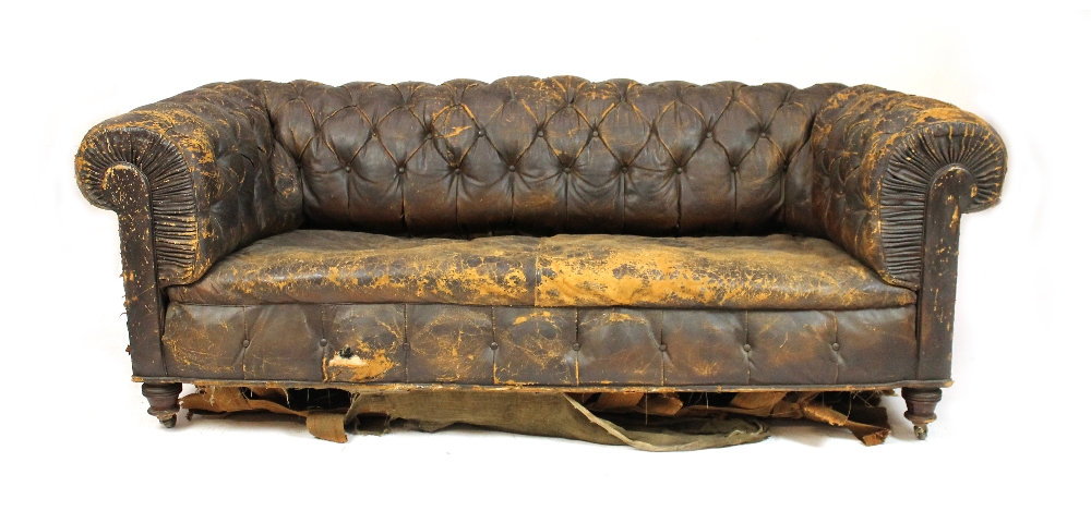 Appraisal: A th century button leather upholstered chesterfield sofa on turned