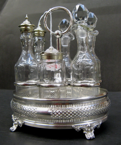 Appraisal: SIX BOTTLE SILVER PLATED CASTOR SET having a filigreed and