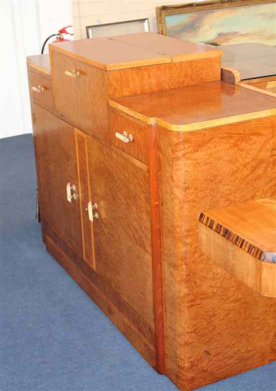 Appraisal: An Art Deco maple cocktail cabinet with an arrangement of