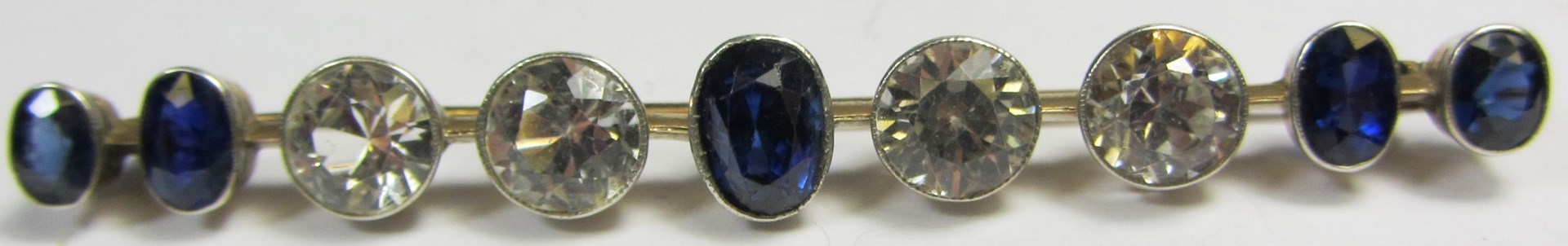 Appraisal: A gold sapphire and colourless gem set bar brooch collet