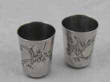 Appraisal: Two Russian silver vodka tots with traditional engraved decoration -