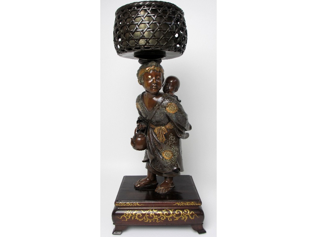 Appraisal: A Japanese bronze figure of a mother carrying her child