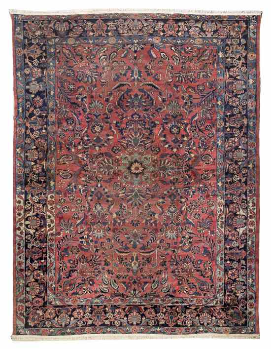 Appraisal: A Persian Wool Rug having allover foliate decoration on an