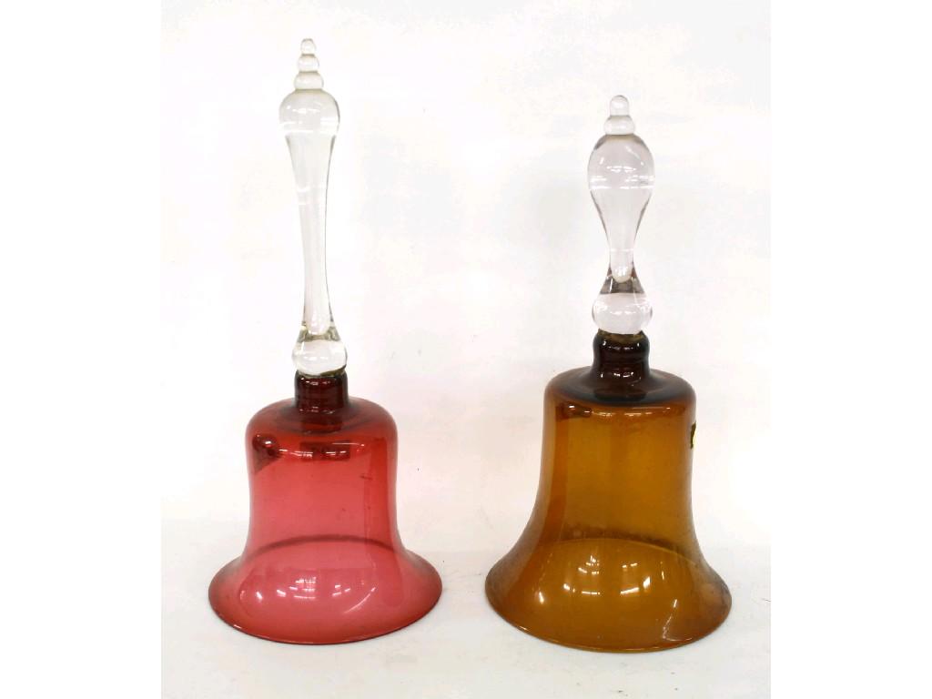 Appraisal: Two cranberry glass bells with clear glass baluster handles and