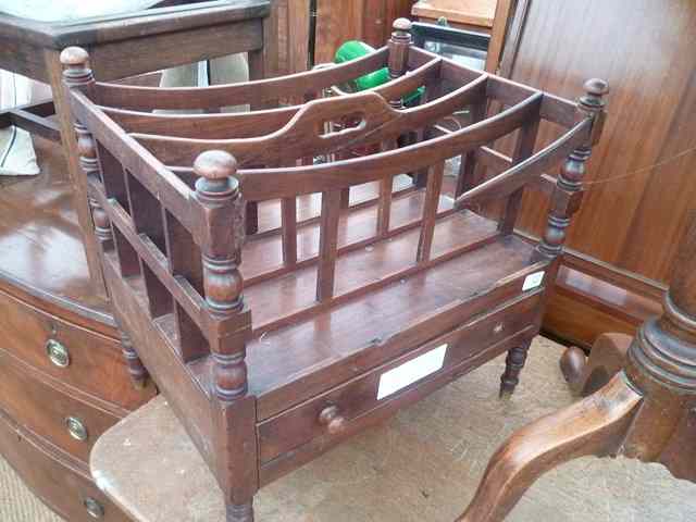 Appraisal: A VICTORIAN MAHOGANY FOUR SECTION CANTERBURY with turned supports and