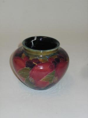 Appraisal: A MOORCROFT POTTERY MINIATURE VASE of squat baluster form tube