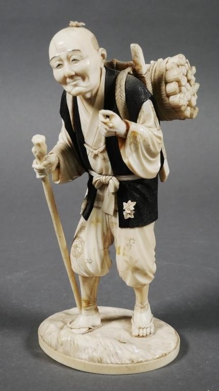 Appraisal: Hand carved ivory statue of a firewood vendor with a