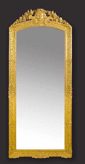 Appraisal: TALL PIERCED AND CARVED GILTWOOD MIRROR A LA TETE D'APOLLON