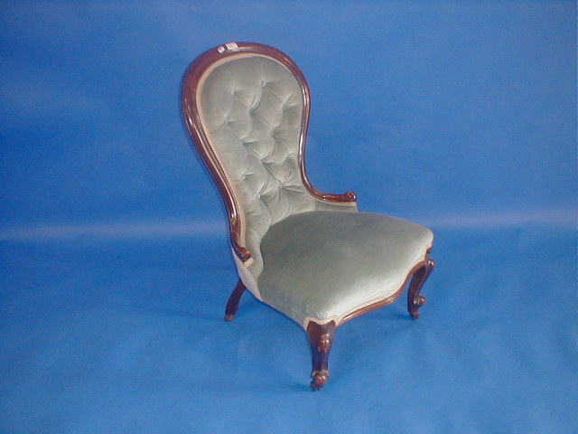 Appraisal: A Victorian walnut spoon back nursing chair upholstered in blue