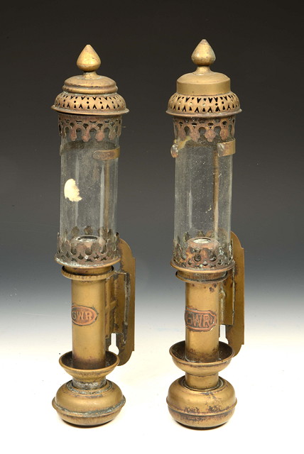 Appraisal: TWO SIMILAR BRASS CANDLE LANTERNS with cylindrical shades and wall