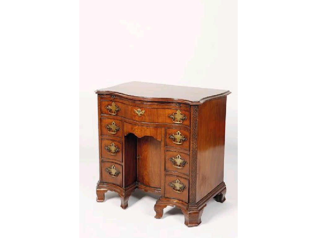 Appraisal: A GEORGE III STYLE MAHOGANY SERPENTINE FRONTED KNEE HOLE DESK