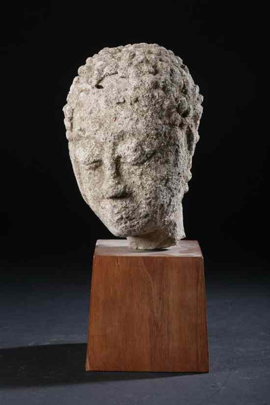 Appraisal: THAI STONE HEAD OF BUDDHA th century On a wood