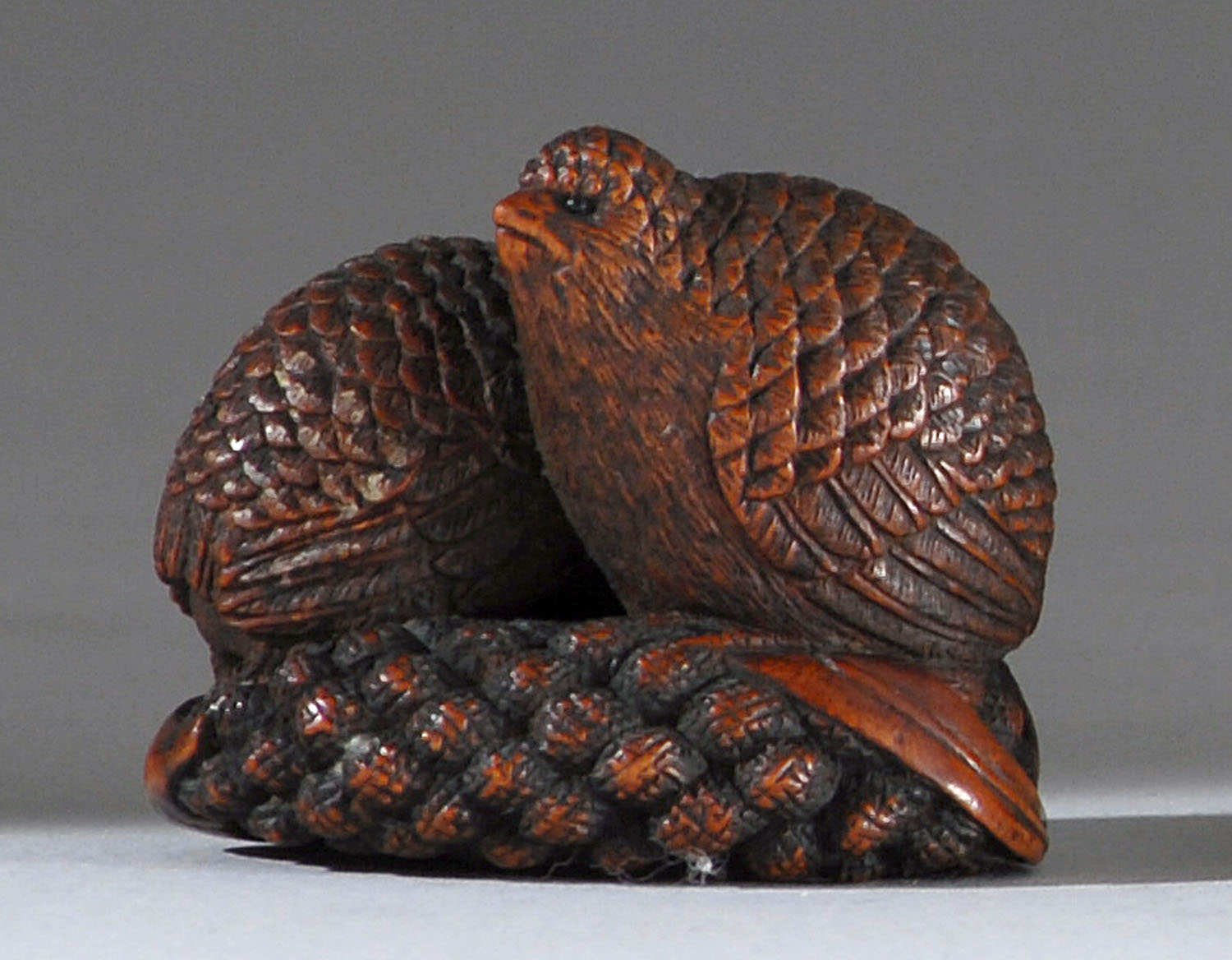 Appraisal: WOOD NETSUKE th CenturyIn the form of two quail with