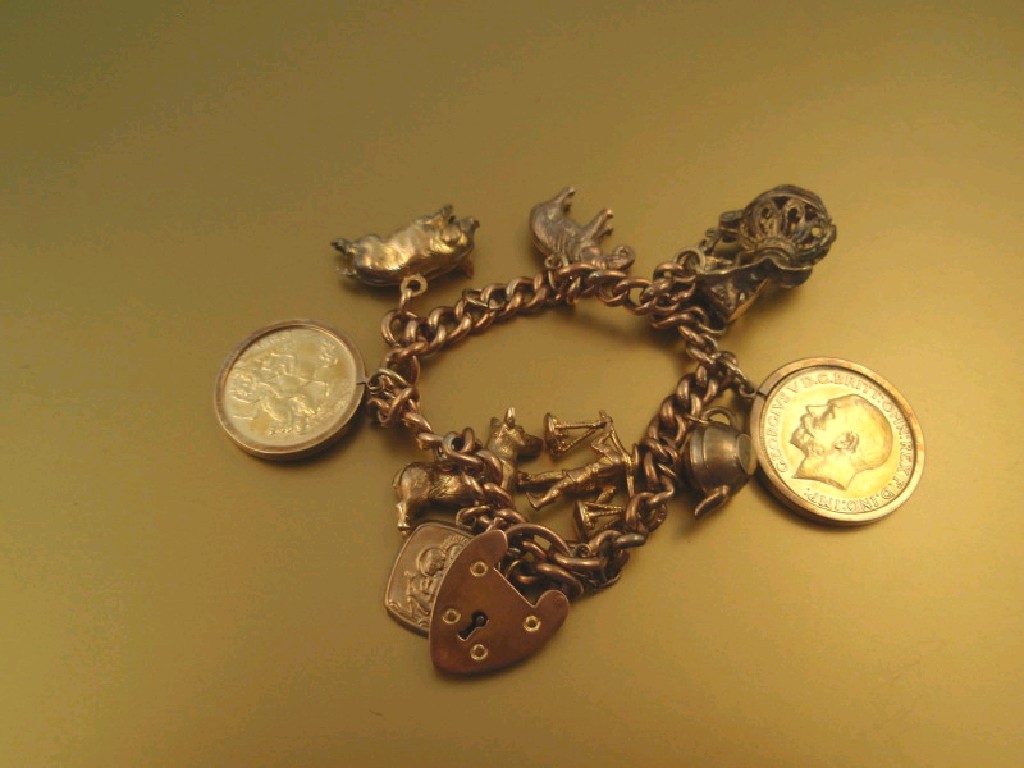 Appraisal: A ct gold curb link charm bracelet with charms attached