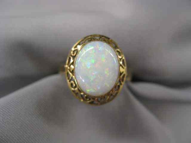 Appraisal: Opal Ring carat fiery oval cabochon in k yellow gold