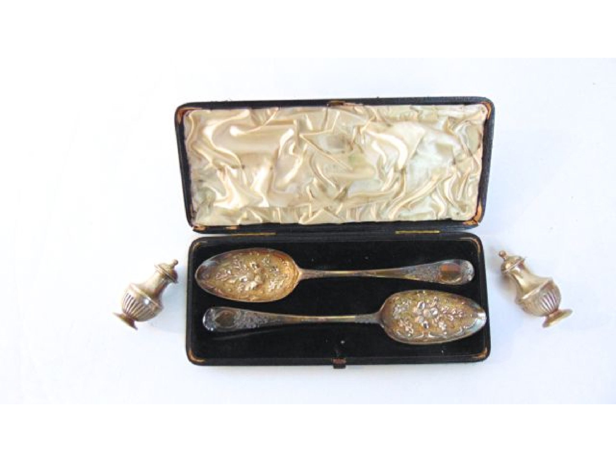 Appraisal: A cased pair of George II silver gilt berry spoons