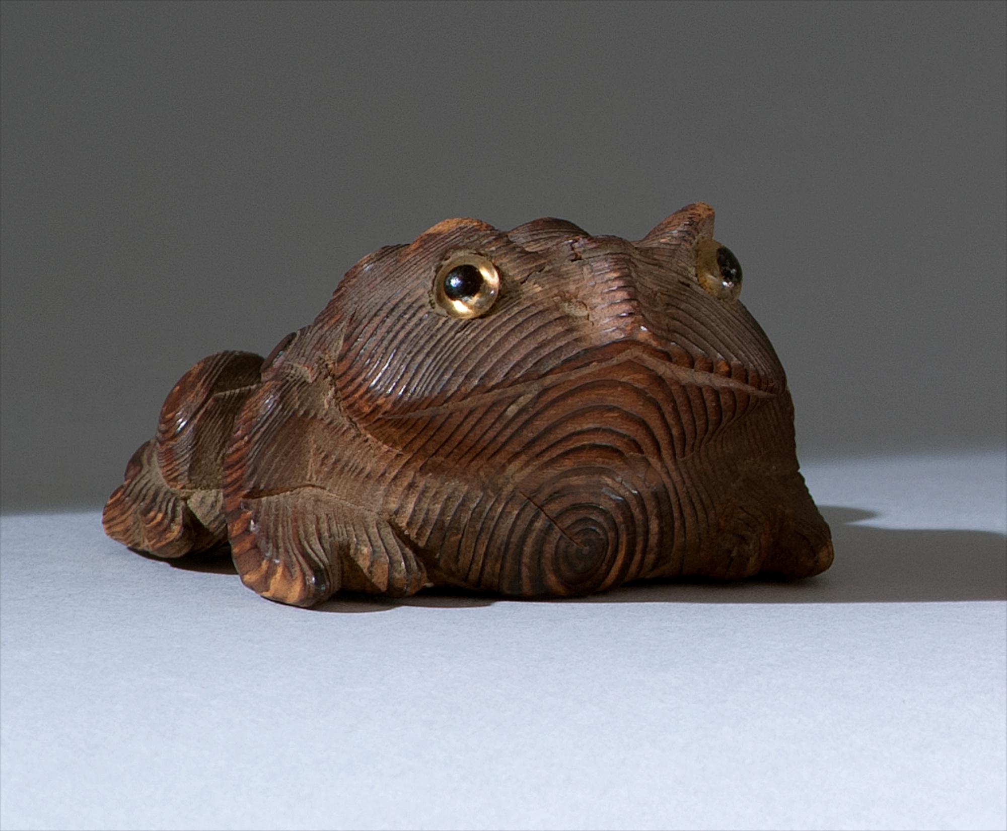 Appraisal: WOOD NETSUKE Meiji PeriodIn heavily grained wood depicting a frog