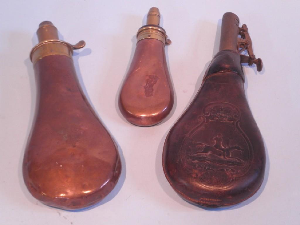 Appraisal: A copper and brass powder flask in embossed leather powder