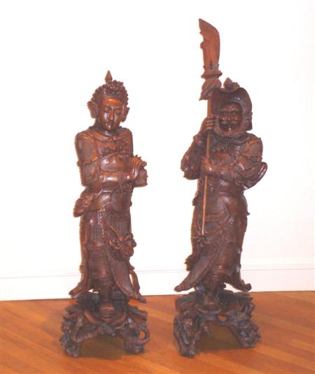 Appraisal: A large pair of Japanese hardwood figures depicting a warrior