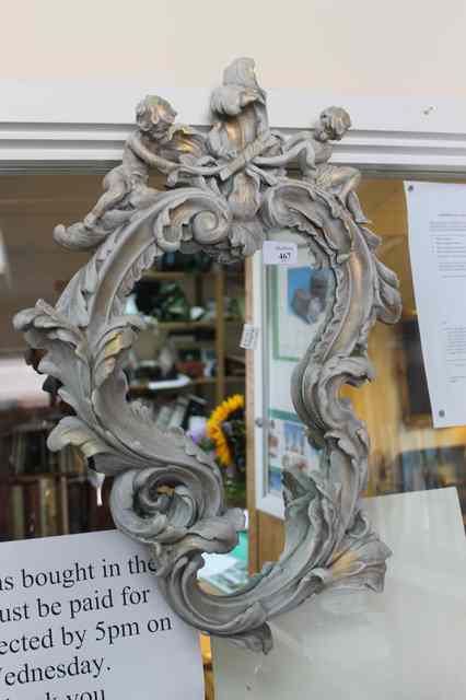 Appraisal: A ROCOCO STYLE WALL MIRROR the shaped mirror with shaped