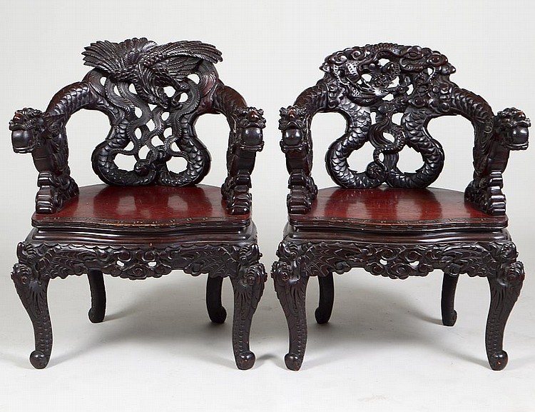 Appraisal: PAIR OF CHINESE EXPORT CARVED DARK WOOD DRAGON ARMCHAIRSCirca Each