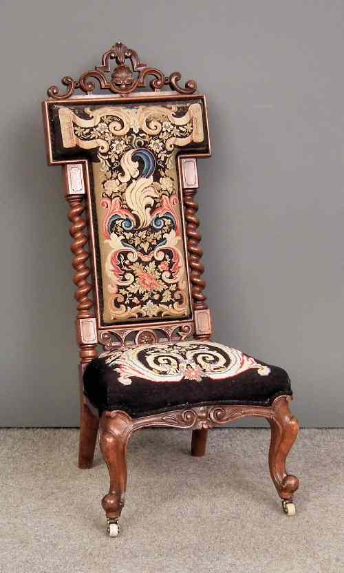 Appraisal: A Victorian walnut nursing chair with carved cresting and spiral