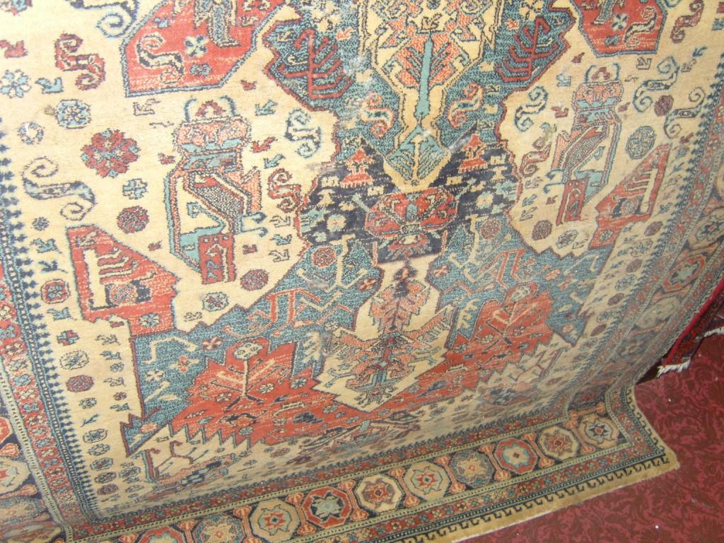 Appraisal: A beige ground wool rug with stylised floral decoration in