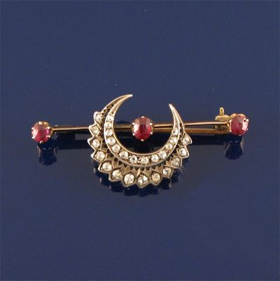 Appraisal: A late Victorian diamond and ruby crescent bar brooch the