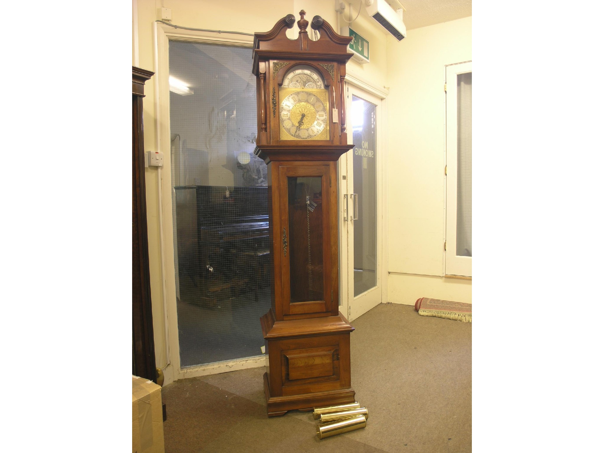 Appraisal: A Georgian-style longcase clock arched brass dial with moon phase