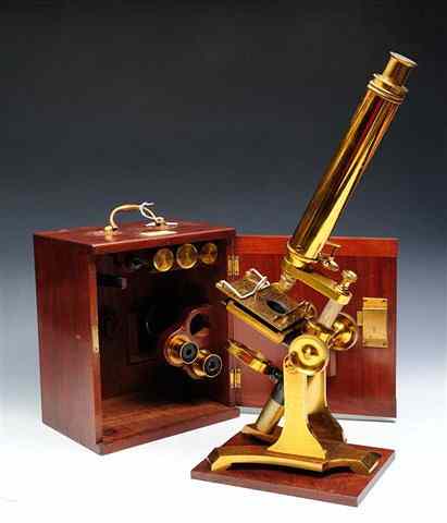 Appraisal: A VICTORIAN BRASS MICROSCOPE with lens attachments contained within a