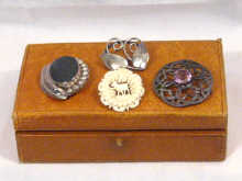 Appraisal: A mixed lot comprising three silver brooches and one carved