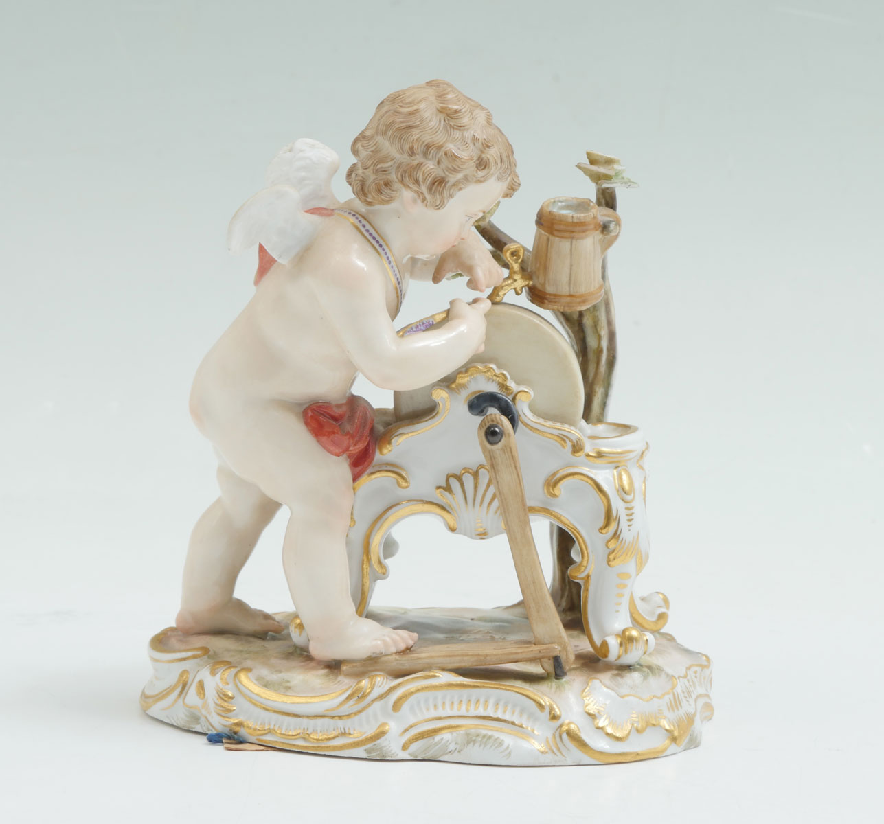 Appraisal: MEISSEN FIGURE SHARPENING ARROW Meissen porcelain cherub sharpening his arrows