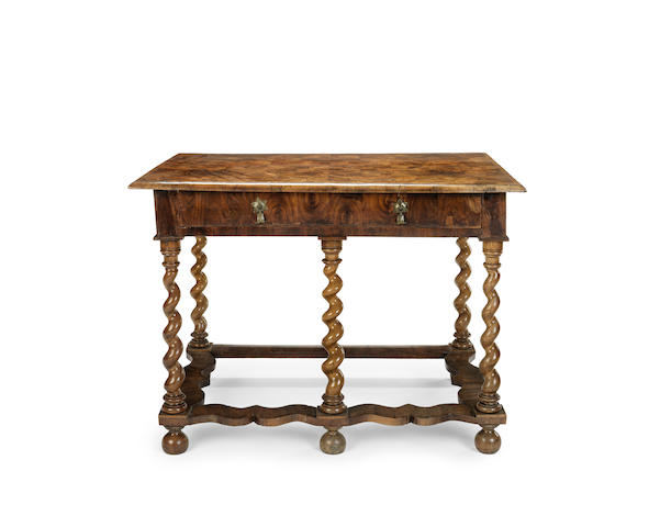 Appraisal: A walnut oyster veneered side table the overhanging rectangular top