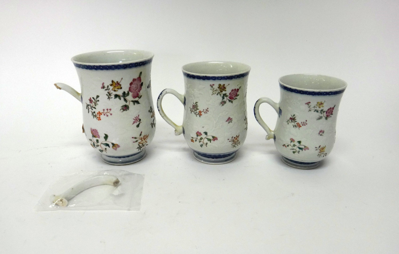 Appraisal: A graduated set of three Chinese famille-rose bell shaped mugs