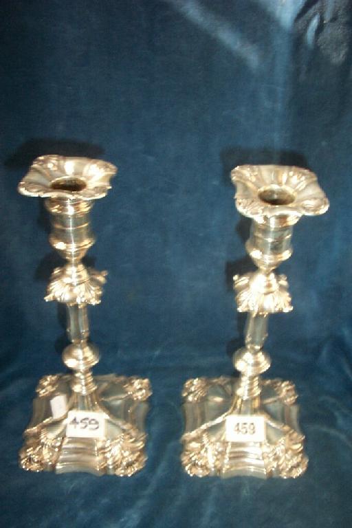 Appraisal: A pair of Georgian style silver candlesticks of shaped form