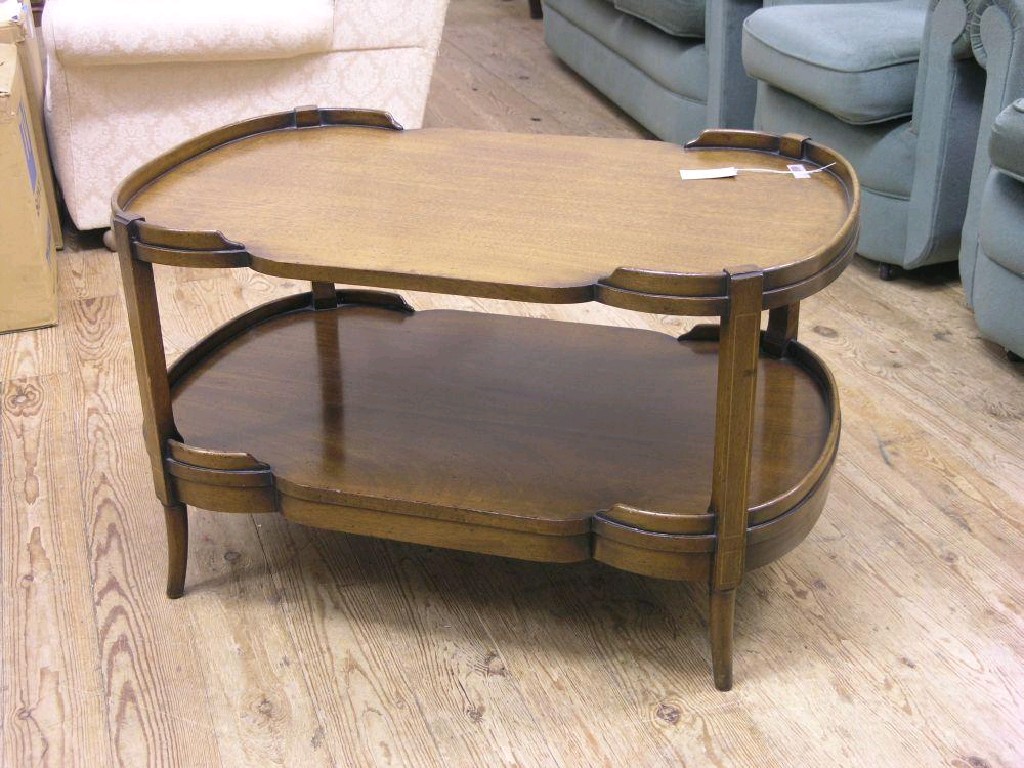 Appraisal: A reproduction mahogany coffee table near-kidney shape with partial tray