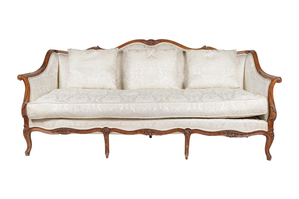 Appraisal: FRENCH PROVINCIAL WALNUT CANAPEearly th century covered in cream-colored floral