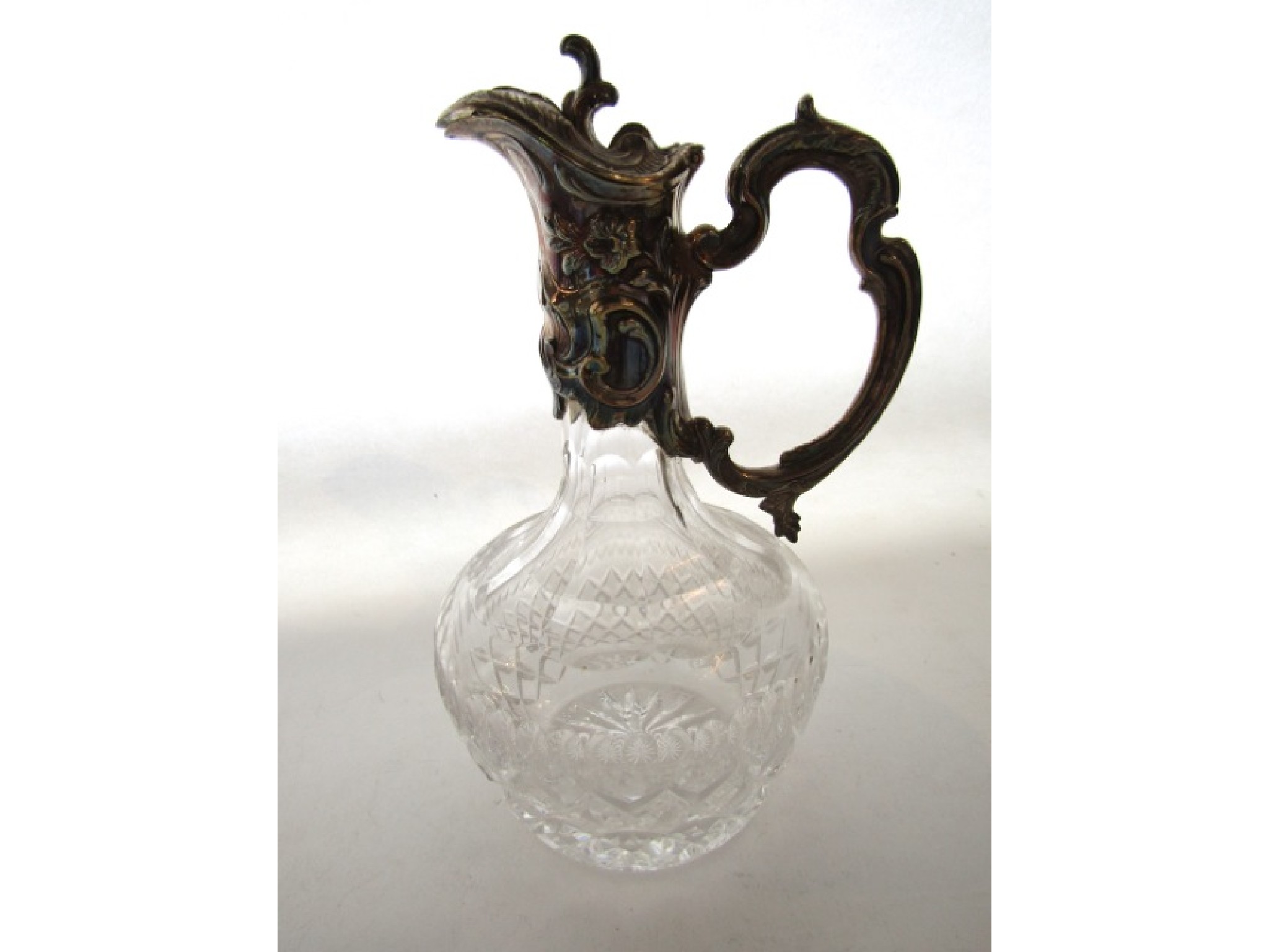 Appraisal: A Continental silver-mounted cut-glass claret jug standard with floral decoration