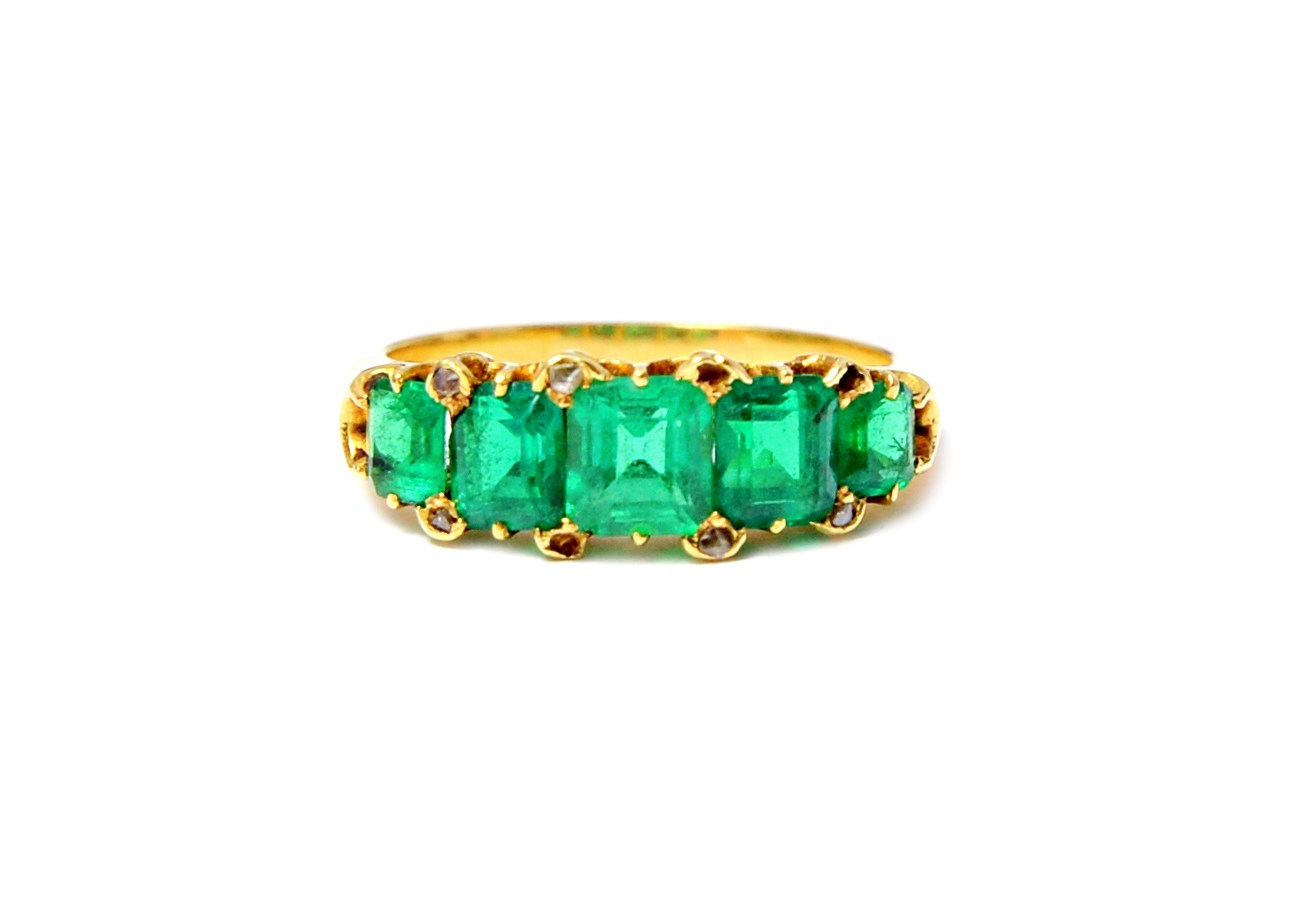 Appraisal: A gold and emerald set five stone ring mounted with