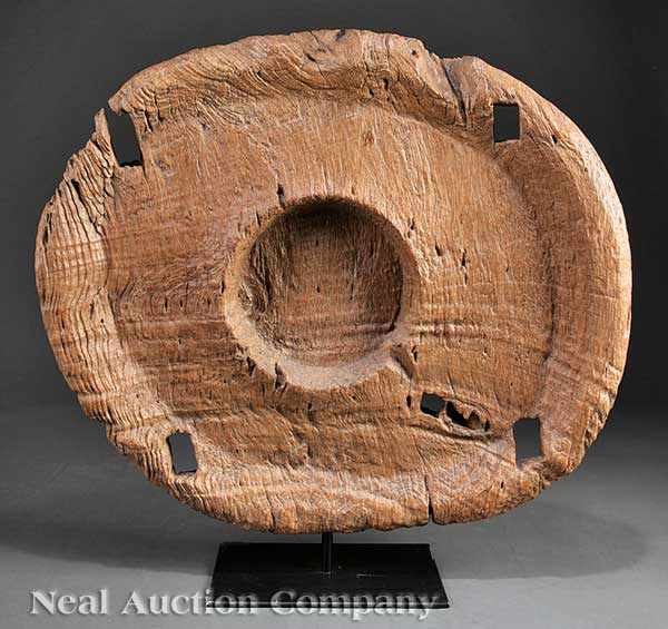 Appraisal: A Southeast Asian Teak Grinding Wheel solid oval body with