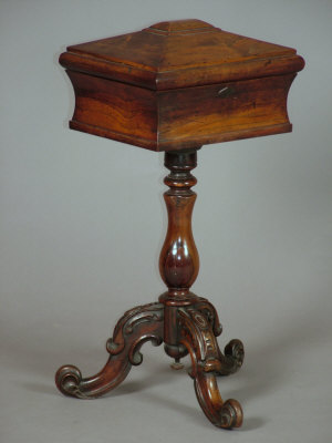 Appraisal: A Victorian rosewood pedestal teapoy with sarcophagus shaped top upholstered