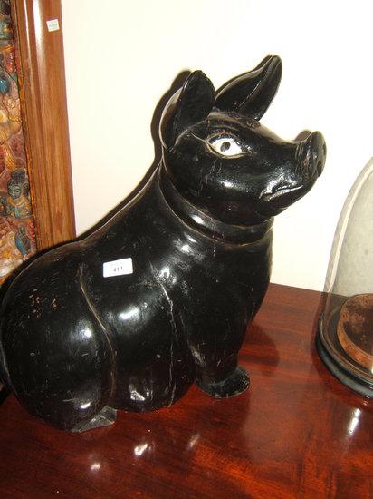 Appraisal: A dark stained carved wooden sculpture of a pig high