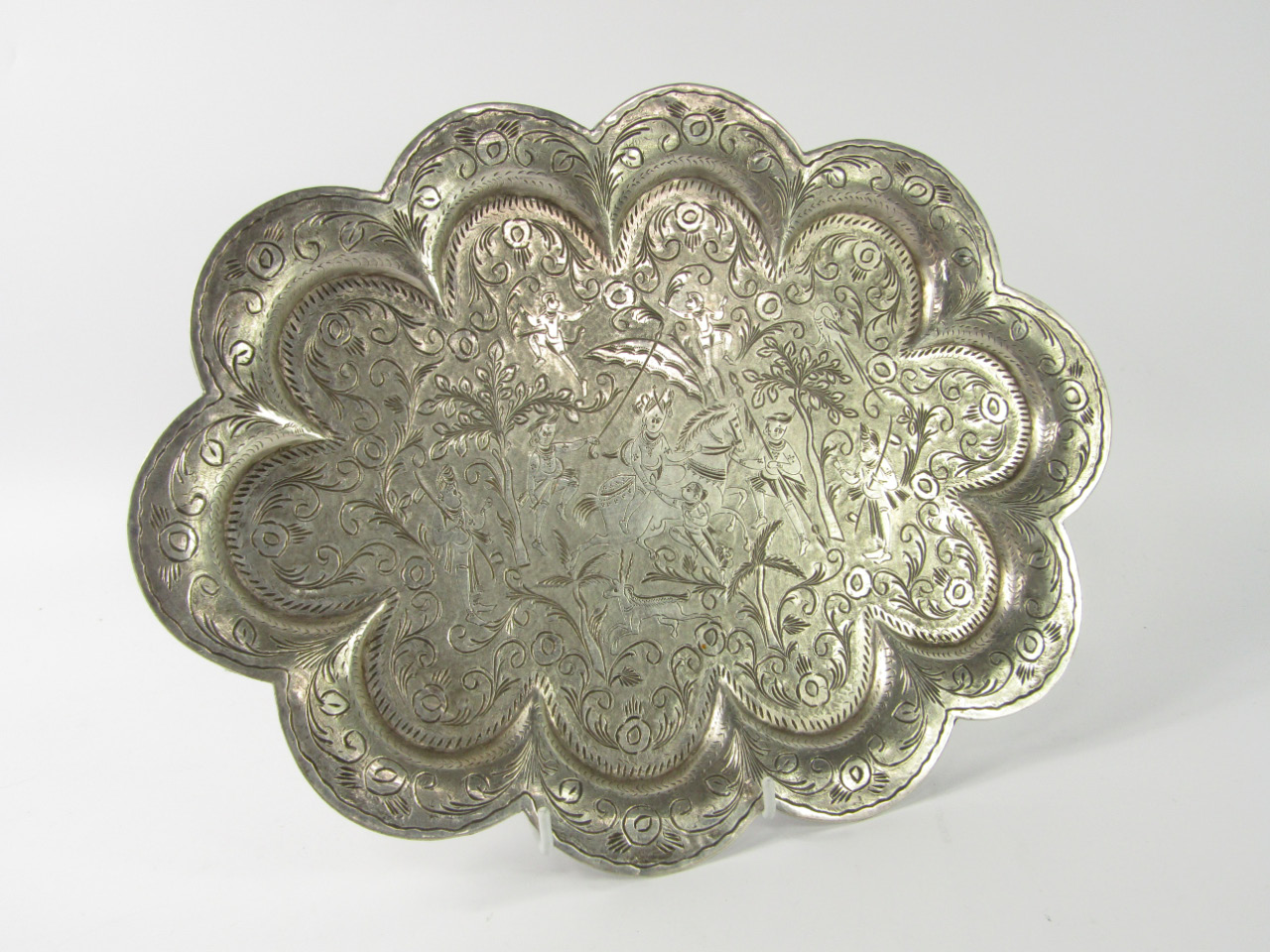 Appraisal: An Indian white metal tray of lobed oval form engraved